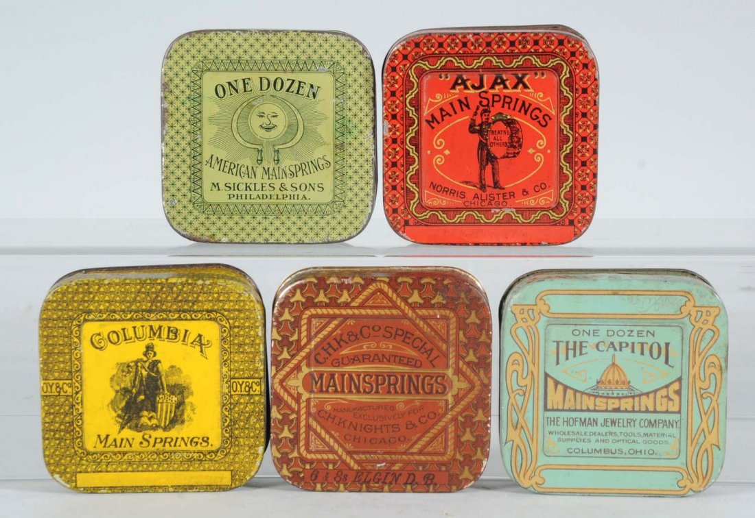 Lot of 5: Mainspring Round Corner Tins.: Colorful vintage mainspring tins; Ajax, One Dozen, The Capitol, C.H.K. & Co., Special and Columbia from American Can, Somer Bros. and Haskers & Marcuse Co. Condition (Fine - Fine Plus). Size Each: 3" 