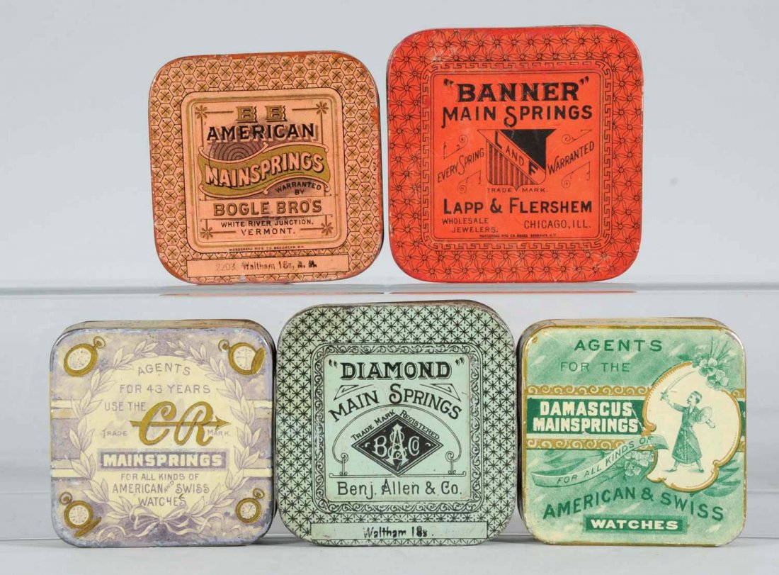 Lot of 5: Mainspring Round Corner Tins.: Colorful vintage mainspring tins; Banner, C.R. American, Diamond and Damascus. Condition (Fine Plus). Size Largest: 3 - 1/2" L.