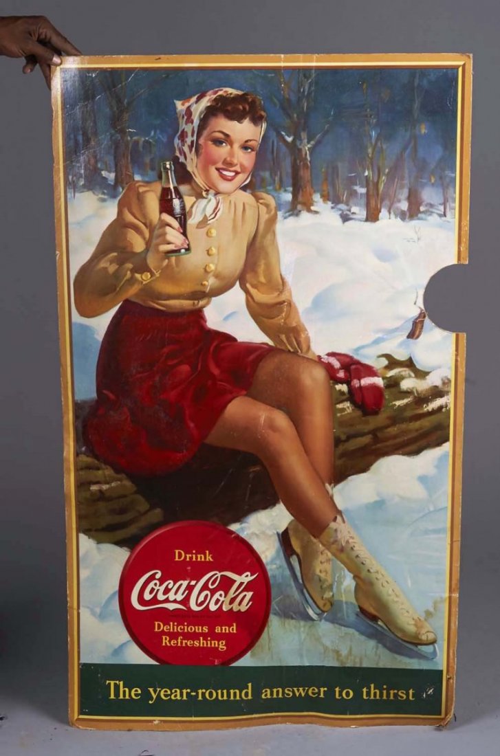 Tall Coca Cola Cardboard Litho Advertising Sign: Has "The Year Round Answer to Thirst" slogan, printed by Snyder & Black of New York. Image shows an Auburn haired beauty on ice skates, circa 1940. Water damage on lower edge, half-moon circle missing