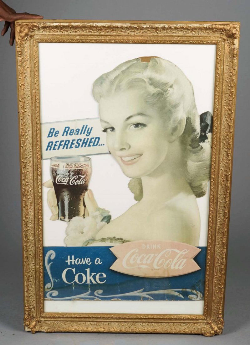 Coca Cola Die-Cut Cardboard Advertising Sign: In ornate frame circa late 1950s, "Have A Coke" featuring fishtail Coca-Cola logo. Some fading. Condition (Fair). Size 31" x 46"