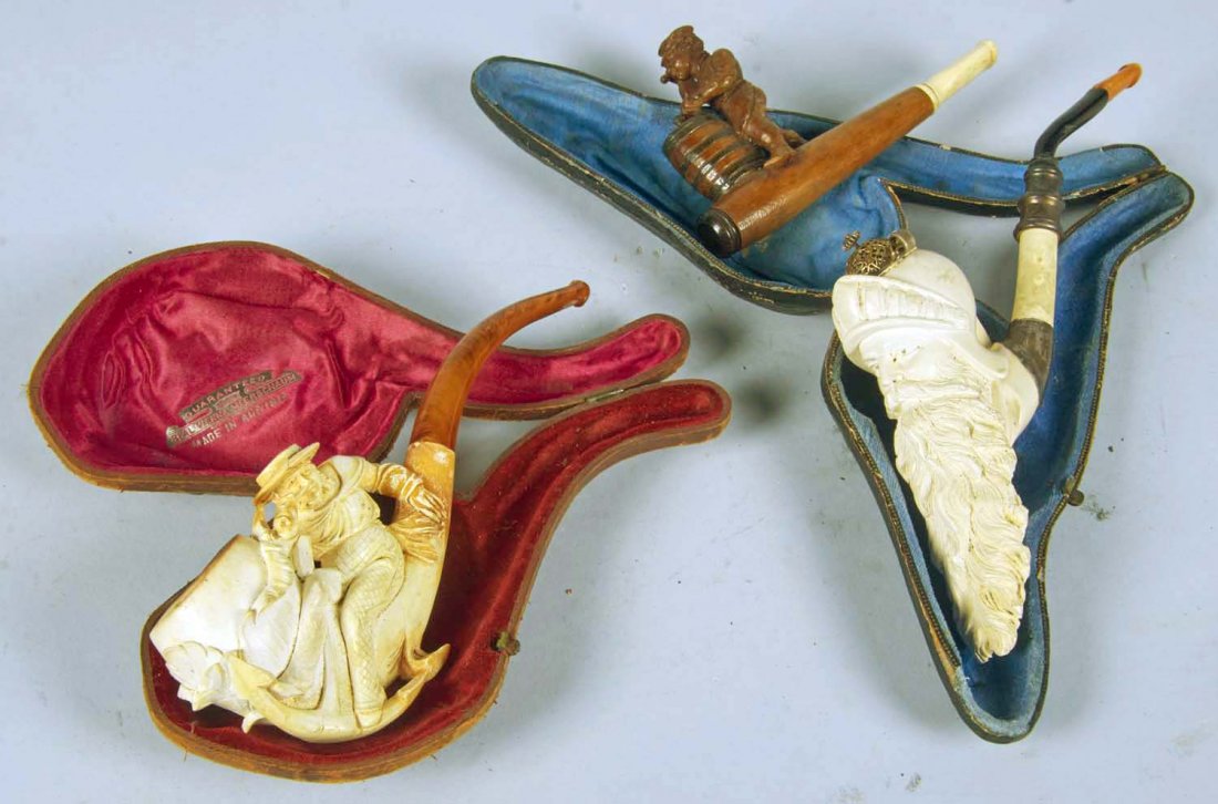 Lot of 3: Pipes.: Lot includes: a meerschaum man in hat with anchor in case marked "Guaranteed Real Vienna Meerschaum Made In Austria", a meerschaum Viking man's head with a long beard and helmet, metal cover for chamb