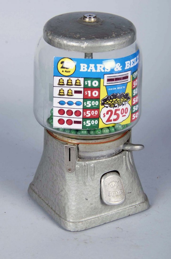 25 Cent Countertop Gambling Ball Vending Machine: With product (gambling balls), glass cylinder globe, silver aluminum base and lid. Some paint chips. With keys. Condition (Good). Size 14" tall