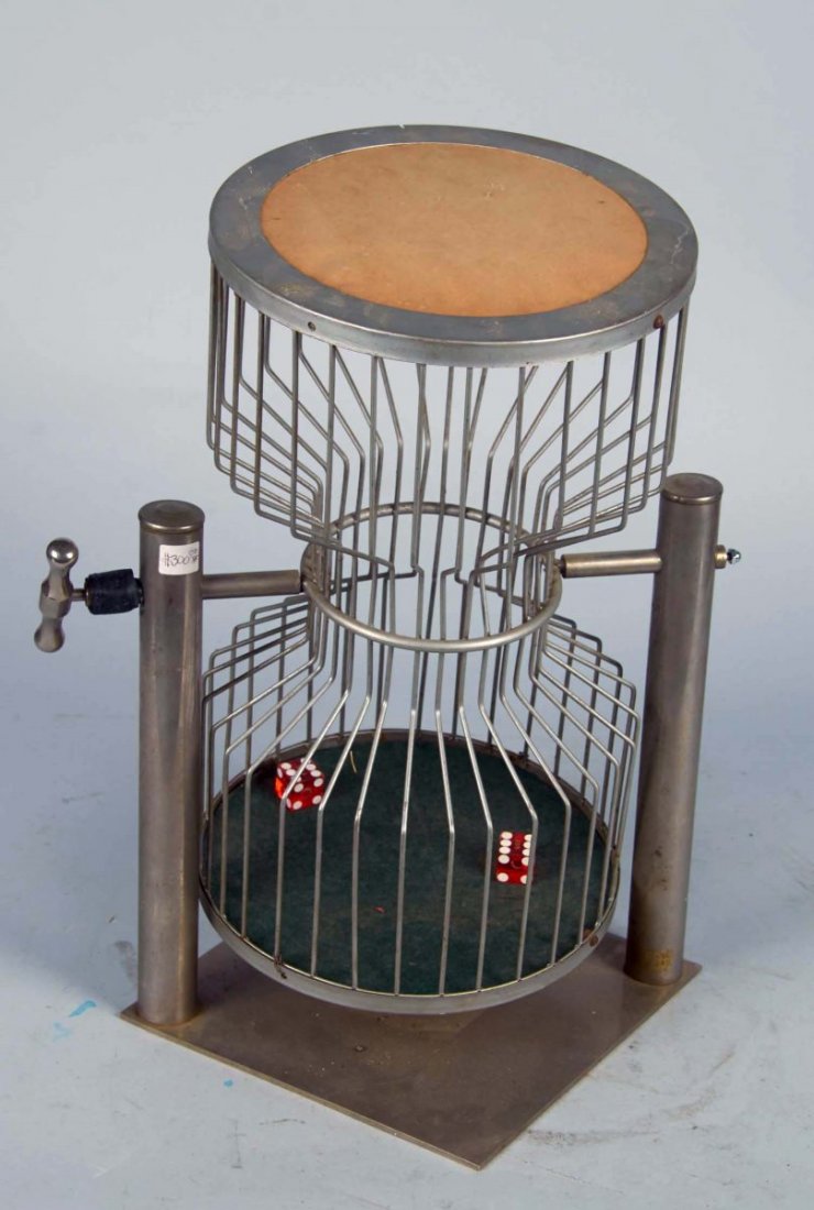 Chuck-A-Luck Dice Game Wire Cage: Hourglass-shaped cage on metal base with pair of contemporary red dice. Cage has handle which allows the cage to turn 360 degrees. Circa 1920s. Condition (Excellent). Size 18" x 9" x 9"