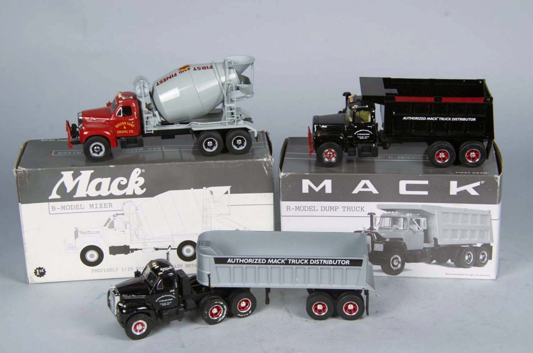 Lot Of 5 First Gear Die-Cast Mack Trucks: 1/34 scale, Including 1 - 1960 Model B-61 dump truck c1996 (10-1/2" x 4" x 6"), 1 - R-Model dump truck c1997 (10-1/4" x 4-3/4" x 5-1/2"), 1 - 1960 Model B-61 tractor & trailer (13" x 4" x 7-1/2"), 1 -