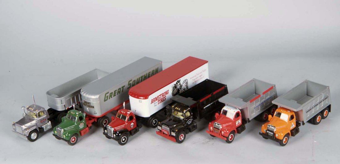 Lot Of 6 First Gear 1/34 Mack Trucks: Including 1 - Tractor trailer c1993 (7-1/2" x 12-1/2" x 4"), 1 - 1960 B-61 tractor & trailer (13" x 4" x 7-1/2"), 1 - R-Model dump truck c1999 (7" x 4" x 14-3/4"), 1 - R-Model dump truck c1997 (10-1/4