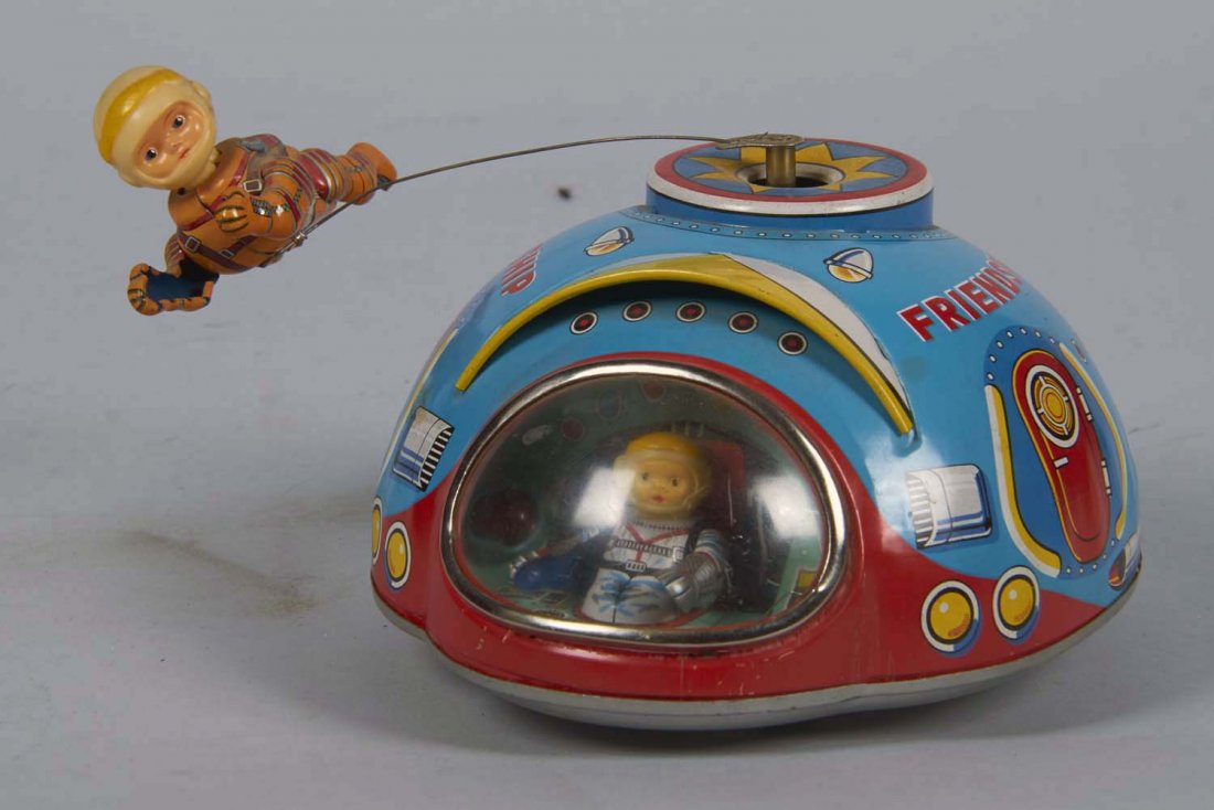 Battery Operated Friendship No. 7 Tin Toy: Battery operated tin toy, Friendship No. 7 with bump and go action. Toy features an astronaut who circles the space craft. Ca. 1960s Condition Excellent Size 7" x 6" x 3-1/4"