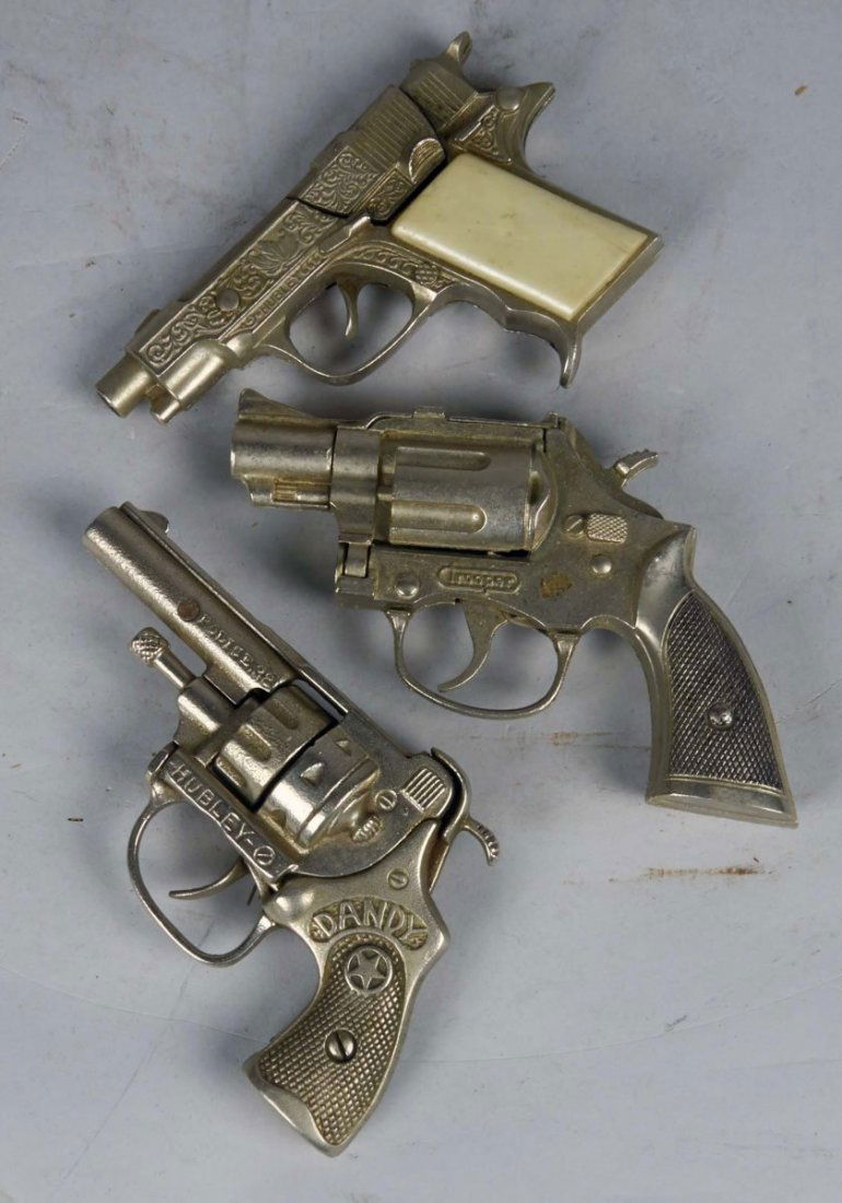 Lot Of 3 Hubley Toy Cap Guns: Including 1 - Hawk Die-Cast Automatic Cap Pistol w/ Fancy Etchings, 1 - Dandy Cast Iron Cap Pistol Police .38 Pat. 1993916 c1935, & 1 - Trooper Cap Pistol Condition Good Size Up to 5.5" long