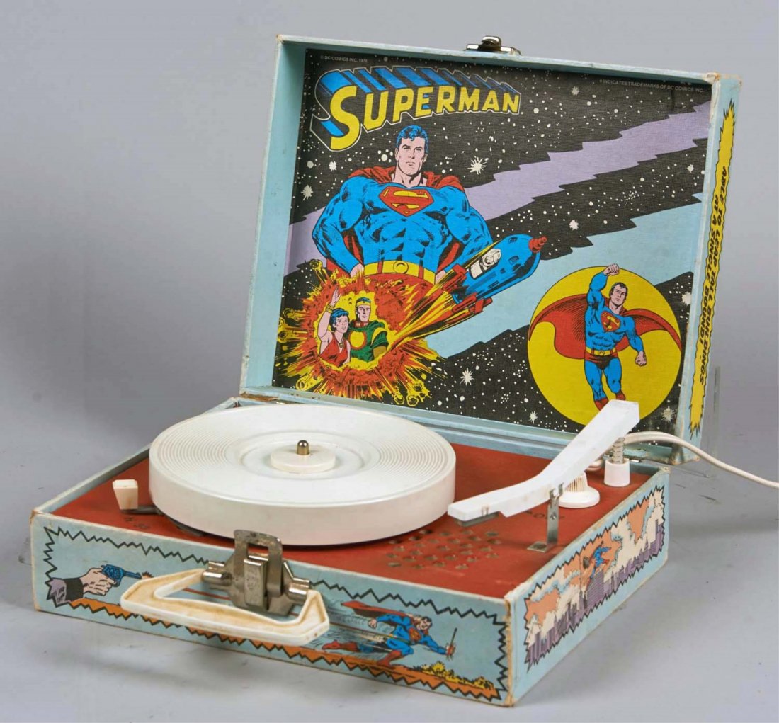 Dejay Electronic Superman Portable Record Player: In cardboard litho case with handle and lock by Dejay Corp. Model SD-19, DC Comics Inc. Copyright 1978. Includes Weatherspoon's Catalyst 33 RPM record. Condition (Very good). Size 4-1/2" x 12" x 9"
