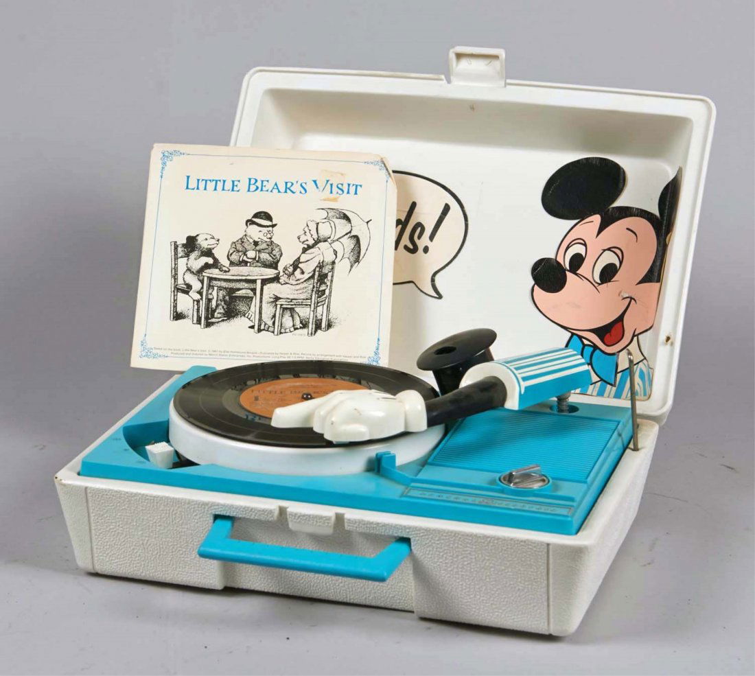 General Electric Mickey Mouse Record Player: Portable electronic record player model RP3122B in plastic litho case with handle and lock. Record player arm resembles Mickey's. Includes "Little Bear's Visit" 33 LP record. Condition (Very good). Si