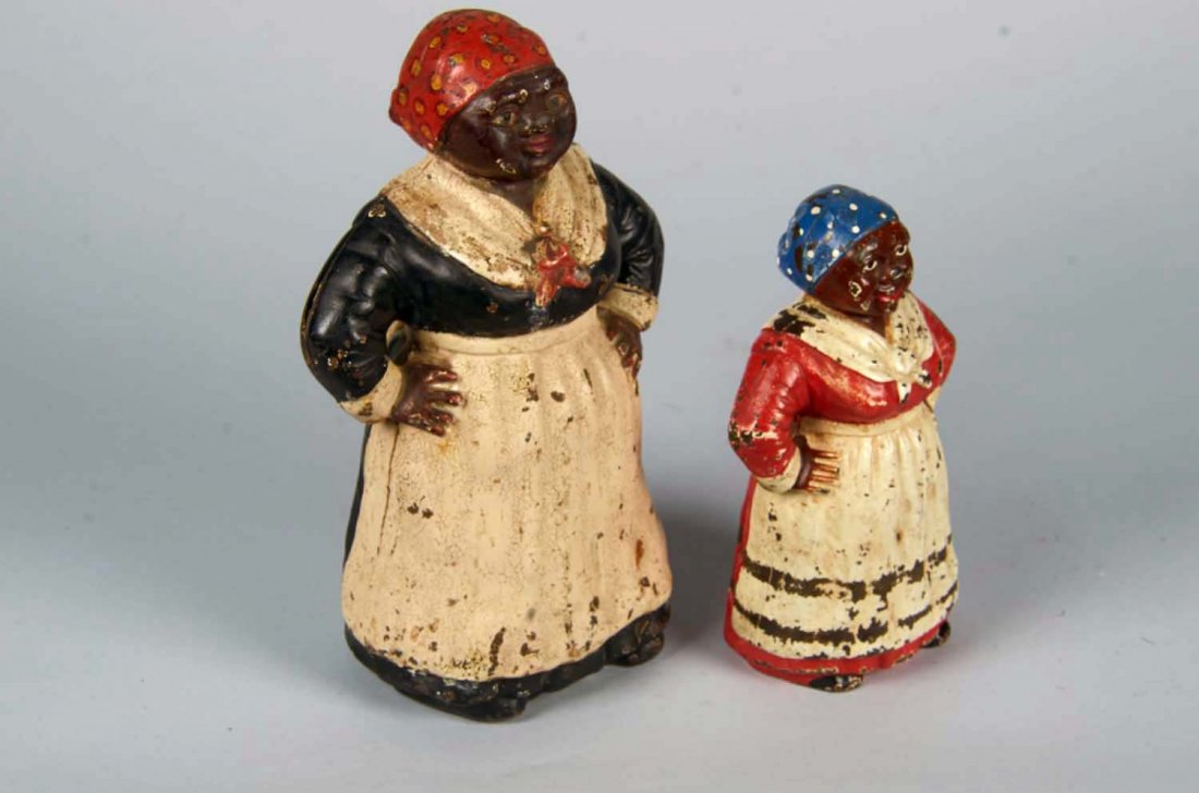 Lot Of 2: Cast Iron "Mammy" Doorstops: Black Americana items including 1 - with red dress and blue polka dot scarf, no markings inside (9" tall) and 1- with black dress and red polka dot scarf, stamped Copyright Hubley (12" tall). Both hav