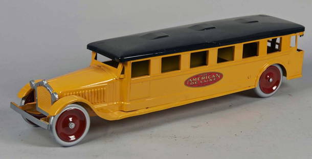 Pressed Steel Bus Toy: Restored in yellow with black top. Has metal wheels with red centers, The American Deluxe Dayton Friction Toy Works side decal, 7 side windows (1 toward rear is smaller), rear curved shade and 3 windo