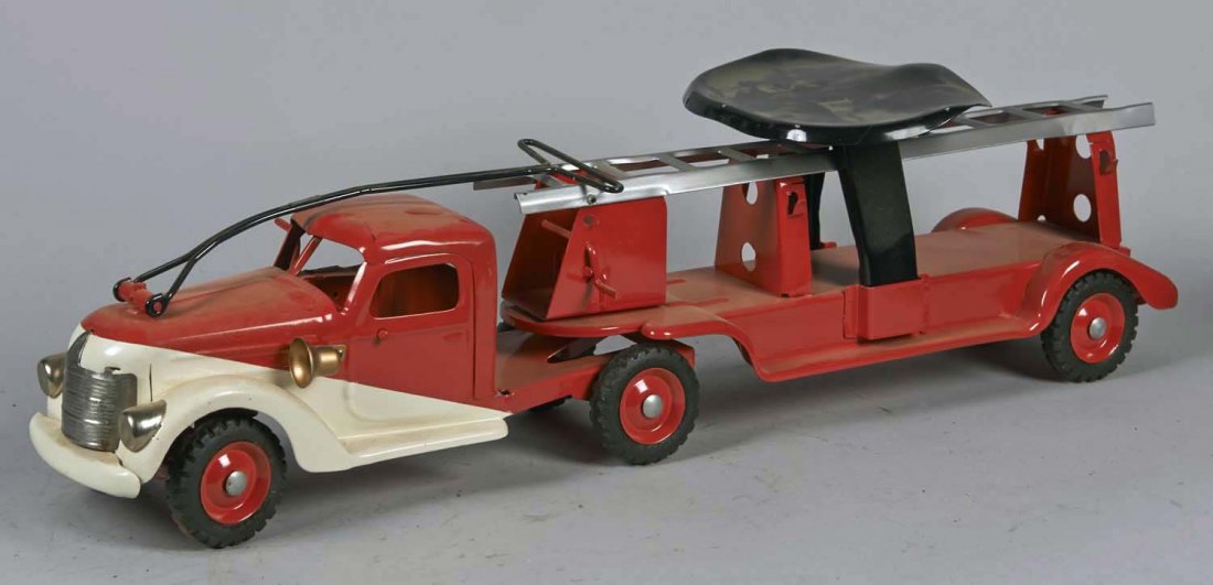 Pressed Steel Buddy L Extension Ladder Truck: Pull N Ride red and white truck with black seat and 6 Buddy L tires. Crank on tractor makes sound. Condition (Restored). Size 30" L.