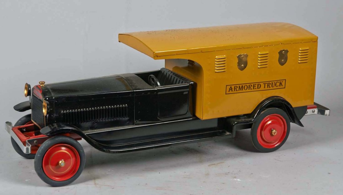 Pressed Steel Packard Armored Truck: Restored in black, yellow, and red with working steering wheel by Ron Lytle of Buffalo Commons Creations. Contemporary. Condition (Restored). Size 28" L.