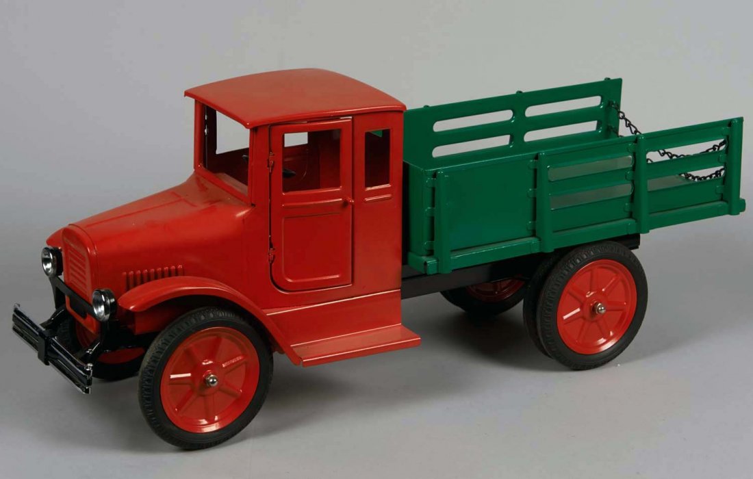 Pressed Steel Buddy L Baggage Truck: Restored in red with green trailer, red wheels and rubber tires, opening doors and working steering wheel. Condition (Restored). Size 26" L.