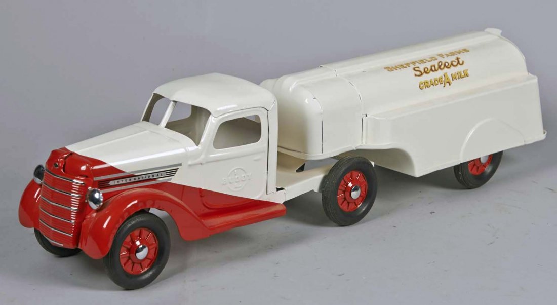 Pressed Steel Buddy L Milk Delivery Truck: Restored in red and white with Sheffield Farms Select Grade A Milk decal, 6 Buddy L tires, and red rims. Condition (Restored). Size 23-1/2" L.