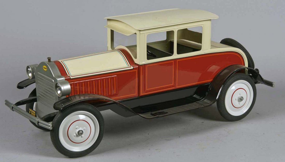 Contemporary Pressed Steel Coupe #1: Tan and red with orange and blue stripes, black fender, rubber hood balloon tires, battery-op headlights, and King K Ken Kovach sticker underneath. Signed Ken Kovach, Ed. Kovach 2000. Condition (Very 