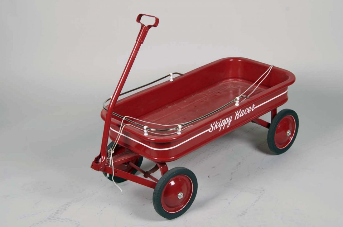 Red Skippy Racer Pull Coaster Wagon: Restored red metal wagon with Skippy Racer decals and nickel railing, circa 1950's. Condition (Restored). Size 15" x 17" x 41" l