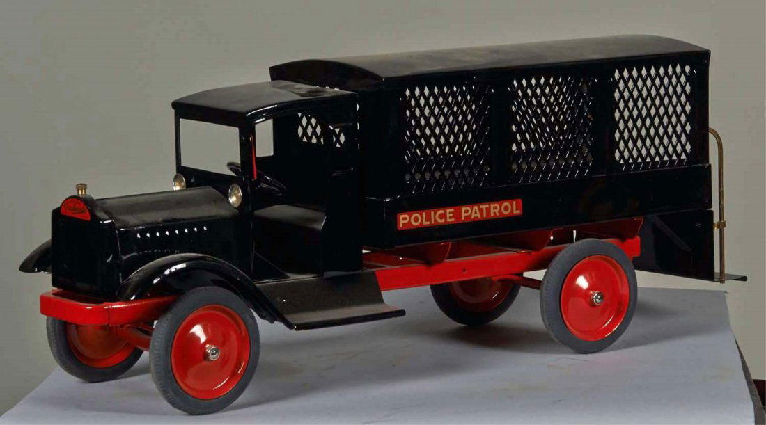 Keystone Police Patrol Wagon with Grated Sides: Restored in black with red wheels and rubber tires. Has gold on red "Police Patrol" decal. Pat. 1925 by Keystone Mfg. Co. Boston, Mass. Condition (Restored). Size 27" L.
