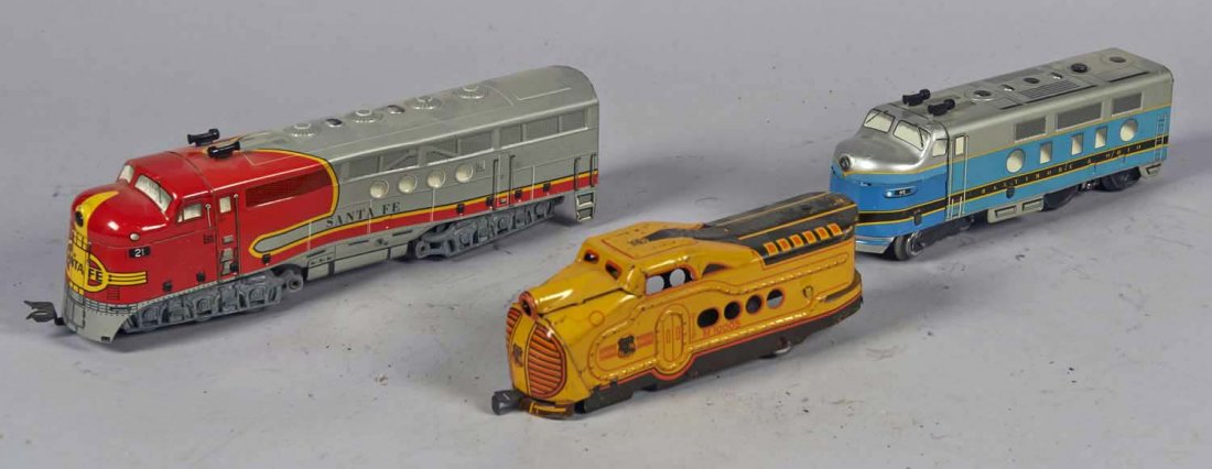 Lot Of 3: Marx Litho Train Engines: Including 1 - Santa Fe no. 21 diesel engine, 1 - Baltimore and Ohio no. 62, and 1 - Union Pacific M10005. Condition (Good). Size 13" x 2" x 3-1/2"