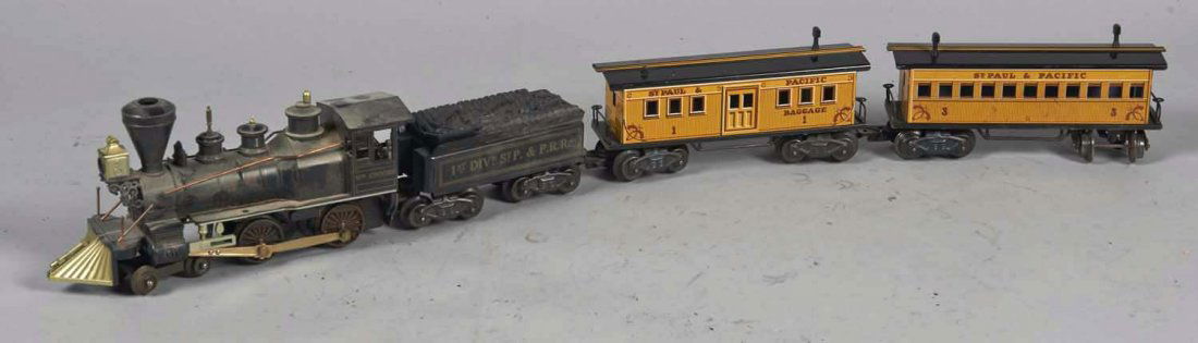 Marx William Crooks St. Paul & Pacific Train Set: Train car set includes plastic locomotive, 9-1/4" x 2-1/4" x 4-1/4", plastic and metal tender car, 5-5/8" x 2" x 2-1/2", & 2 tin litho passenger cars, In original plain box marked #54745 D4, 8-1/2" x