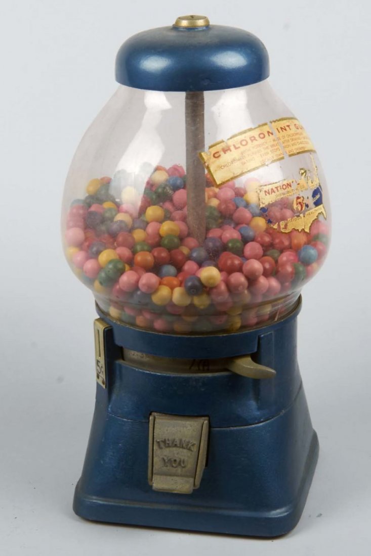 5¢ Blue Regal Countertop Gum Ball Vending Machine: By Regal Products Co. Circa 1940s. Blue cast aluminum base and lid. Glass tear shaped globe with decal. Condition (Very Good). Size 13-1/2" x 6-1/2" x 6-1/2".