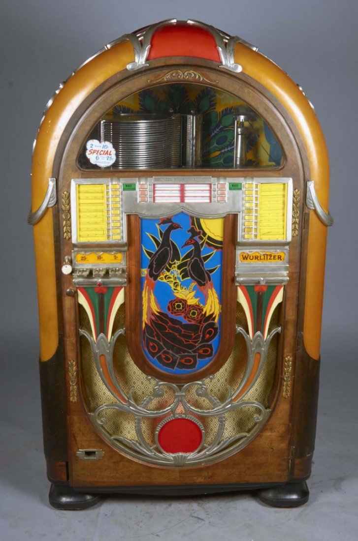 Multi-Coin Wurlitzer Peacock Jukebox Model 850: Accepts quarters, dimes, and nickels, plays 78 rpm records, offers 24 selections, and decal reads, "2 plays for 10 ¢, SPECIAL, 6 plays 25 ¢". Beautiful peacock front cabinet design circa 1941 with c