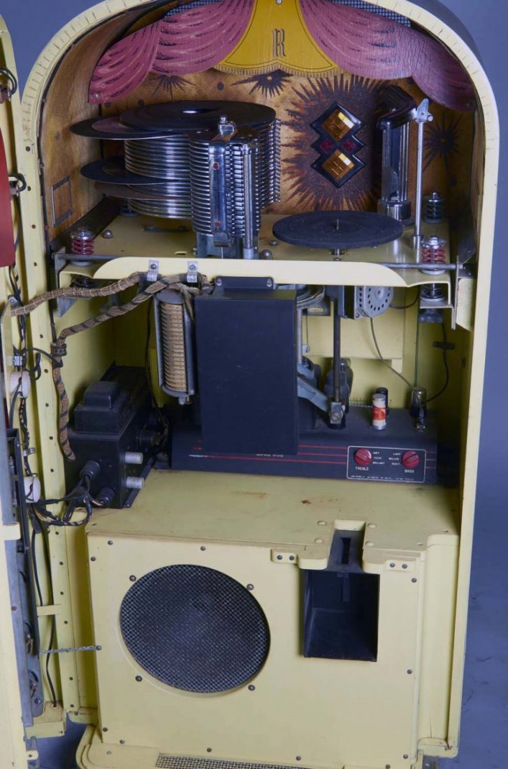 Rock-Ola Magic Glo Jukebox Model G 1428 E: Cabinet has medium wood finish on the sides, with Translucent colored plastic panels on the front. This model offers 20 selections from 78 RPM records and includes keys. Circa 1948-1949. Has small cra