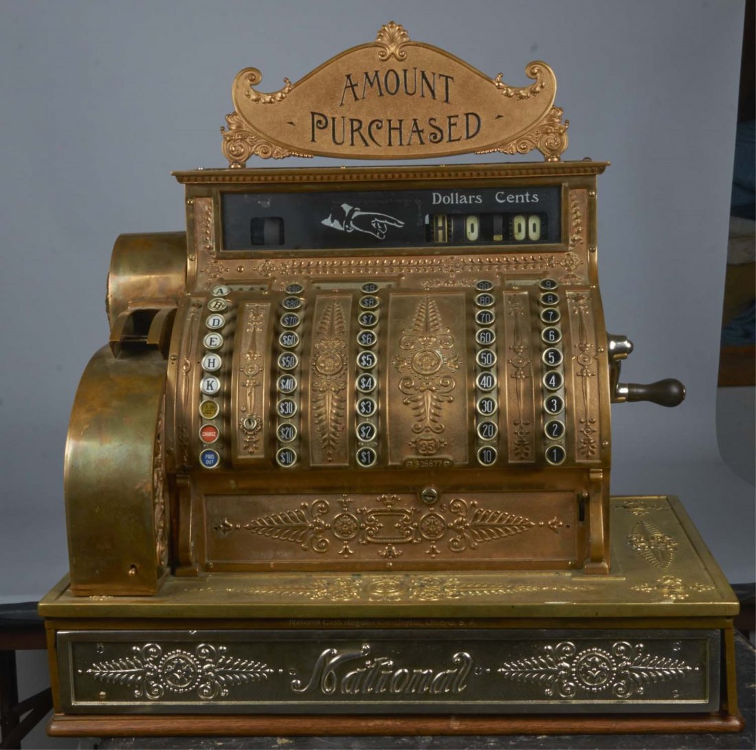 National Cash Register Brass Model 95.: With "Amount Purchased" double sided top sign. Single drawer with "National" embossed nickel drawer front. Ornate receipt side cage, wraparound ledge, wood base, side crank, and empire design. Serial 