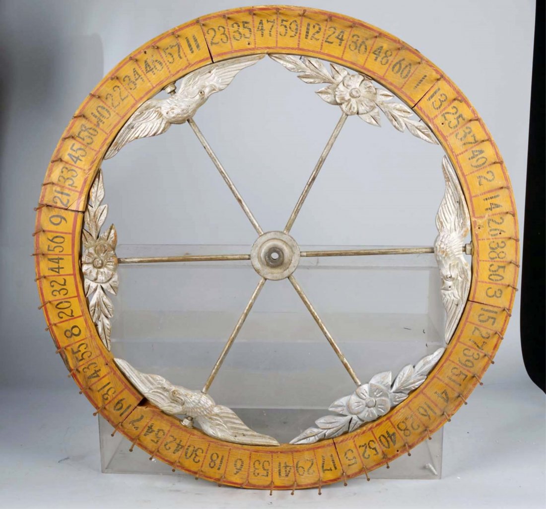 Wood Wall Mount Large Gaming Wheel.: With metal spokes and pegs. Painted numbered wheel with ornate carved wood flower and eagle detail. Slight aging. Condition (Good). Size 32" D