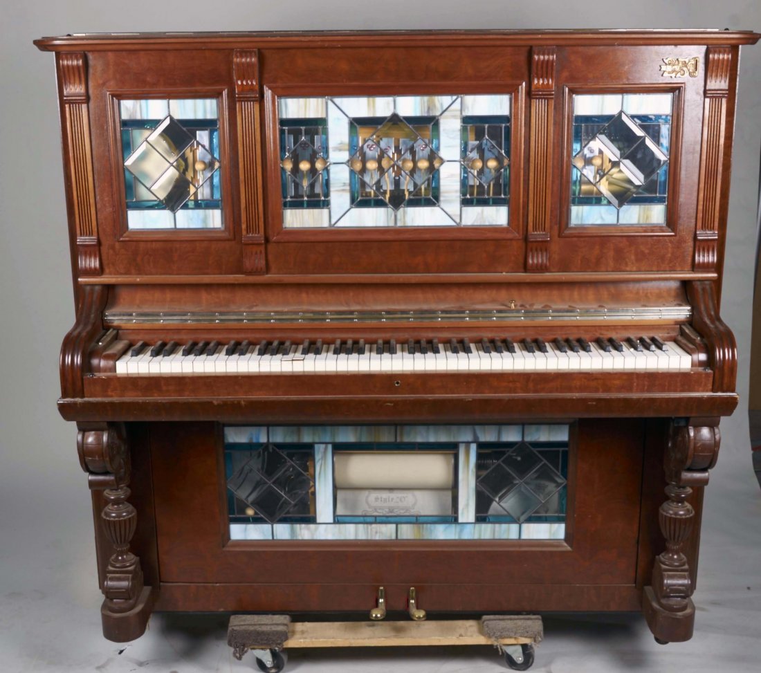 Coin-Op Orchestrion Player Piano: Nice wood cabinet with leaded stained glass upper and lower panels. Instruments includes tambourine, xylophone, drums, and Style "O" piano roll. Condition (Very good). Size 26" x 54.5" x 60"