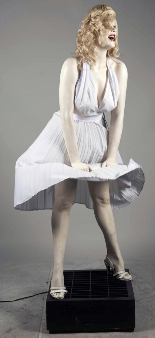 Life Size Marilyn Monroe Fiberglass Statue.: On base resembling subway vent with built in fan to recreate iconic blowing skirt photo, wearing white halter dress, heels, and holding clutch Has very realistic teeth. Condition (Excellent). Size 72"