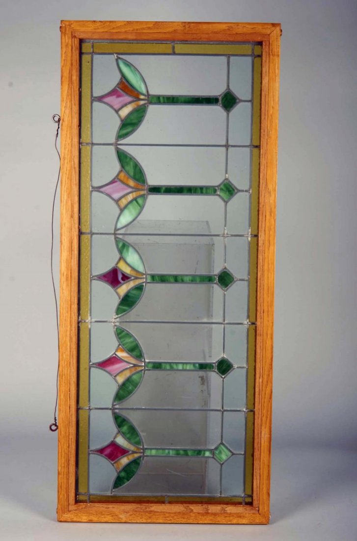 Leaded Stained Glass Window Panel in Frame: Colorful Art Nouveau style with tulip design with hook for hanging. One small pane is cracked. Condition (Very good). Size 18" x 42 1/2"