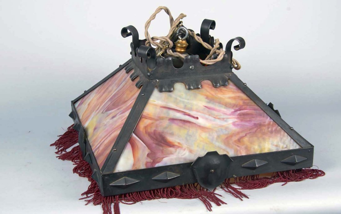 Antique Hanging Stained Glass Lamp: Stained glass lamp with 5" long beaded fringe in a Gothic Medieval design. Has a long cloth cord with a plug on the end and some hanging hardware. Crack on panel. Condition (Very good). Size 20" x 20"