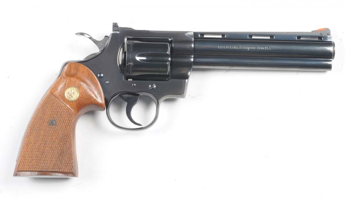 Colt Python Double Action Revolver.**: Serial # K90104 This is a standard Python double action revolver manufactured in 1982 with a 6" barrel, chambered for the .357 magnum, blued finish, and straight cut checkered walnut grips. Gun retain