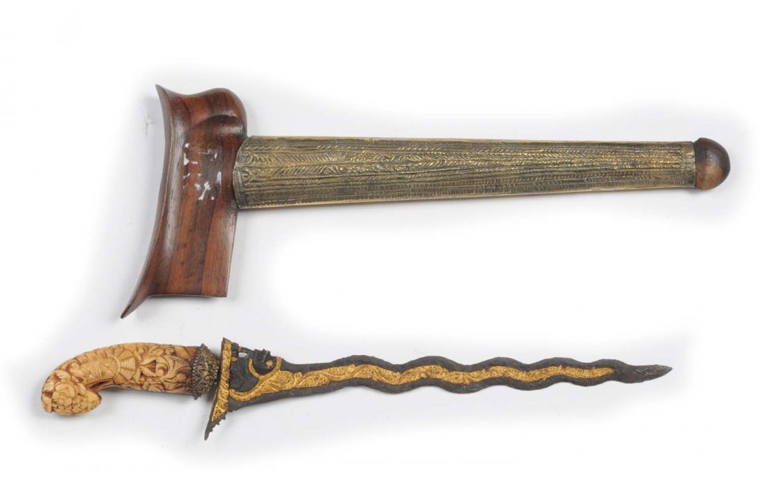 Knife with Fixed Blade.: A fine example of a KRIS. Slim delicate blade with an engraved gilt serpentine stripe down its center. Self guard bears a mythical figure. Handle is elaborately hand carved bone shaped like garuda, a