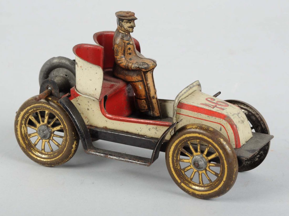 German Tin Litho Fly Wheel Racecar Toy.: Marked No. 46 on hood. Original tin litho driver, gold wash wheels which do show moderate to heavy wear. Some scratching throughout. Condition (Good - Very Good). Size 5 - 1/2" L.