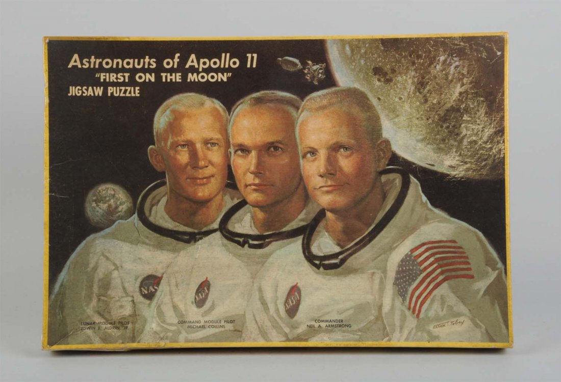 Astronauts of Apollo 11 Jigsaw Puzzle In Box.: Made by the Milton Bradley Co. in the USA. Includes the original box and appears to be unopened and unplayed with. Box has a protective plastic cover it is slightly ripped on top and colorful graphics