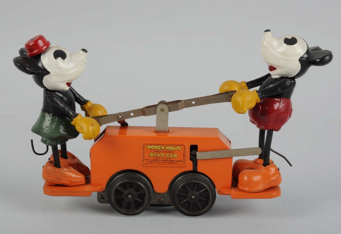 Minnie and Mickey Mouse Handcar.: Toy is made of pressed steel. The figures are attached to both ends of the hand car. One small area of cracking to the back of Minnie, otherwise in great condition. The wind - up key is missing. Condi