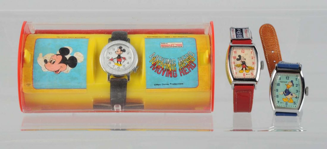 Lot Of 3: Walt Disney Mickey & Donald Watches.: One later Bradley Mickey Mouse watch marked "Mickey Mouse Productions" in original plastic case, an early pre - war Ingersoll Mickey Mouse which has the original $6.95 original price tag on it, and a