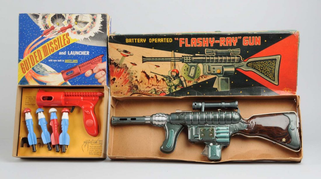 Lot of 2: Ray and Dart Guns.: Includes original boxes. One is made by the Empire Plastic Corporation in America, the other is made by TN, Japan. The American one is a Guided missile and launcher plastic gun, includes four differen