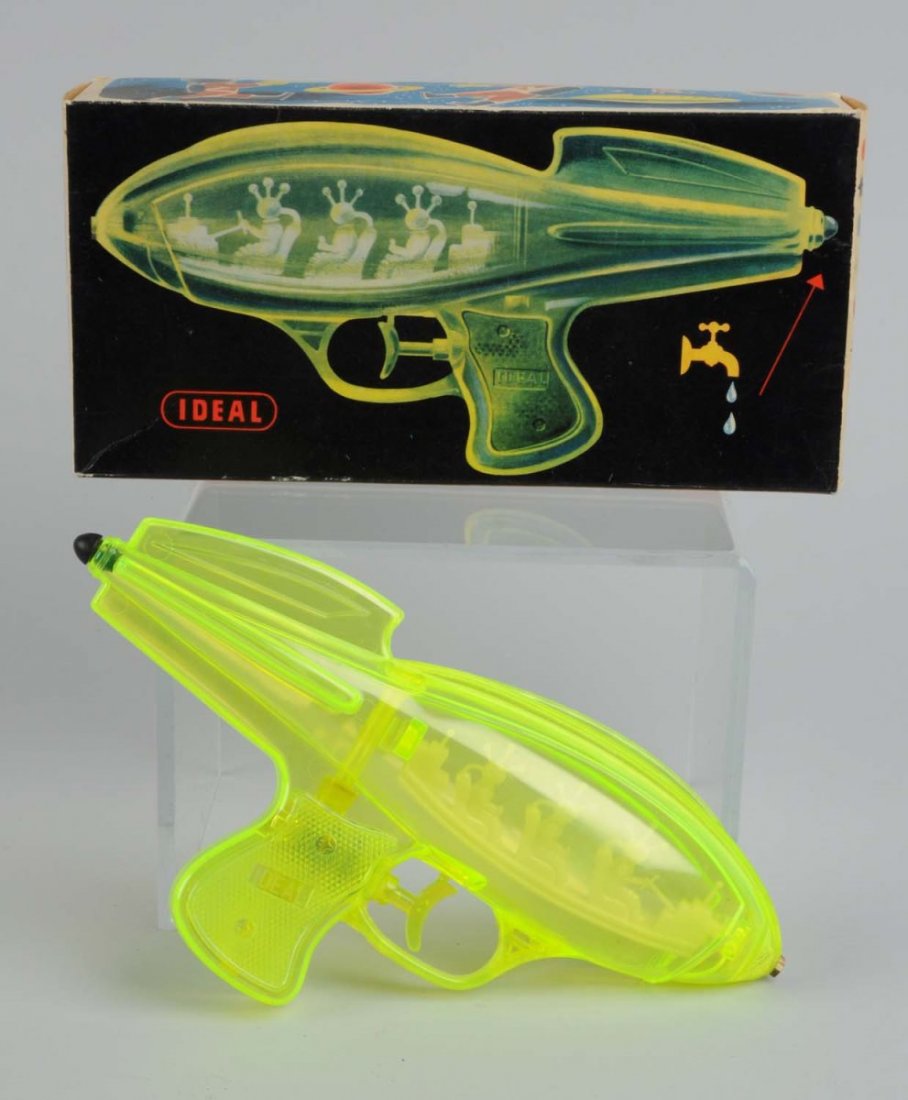 Plastic Water Gun With Original Box.: Made by Ideal in the USA. Gun is made of clear green plastic and has three seated astronauts inside. There are no visible chips to the plastic. The gun has the original plastic tip and rubber stopper