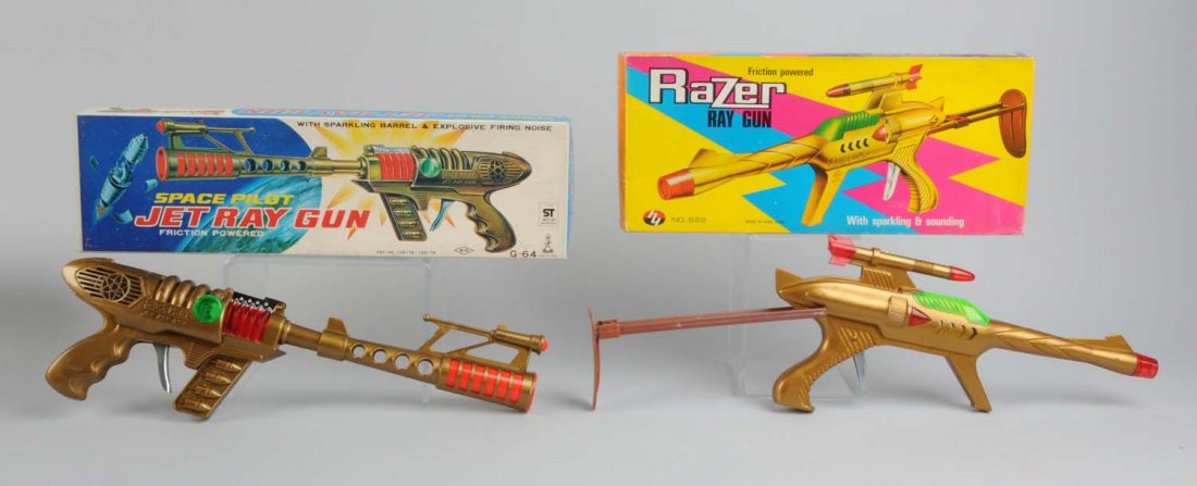 Lot of 2: Razer Ray Gun and a Jet Ray Gun.: Includes original box, has creasing. The Razer Ray gun is friction operated plastic toy, no visible scratches or dents. The Jet Ray gun is also plastic, has clear plastic to see the gears in action. A