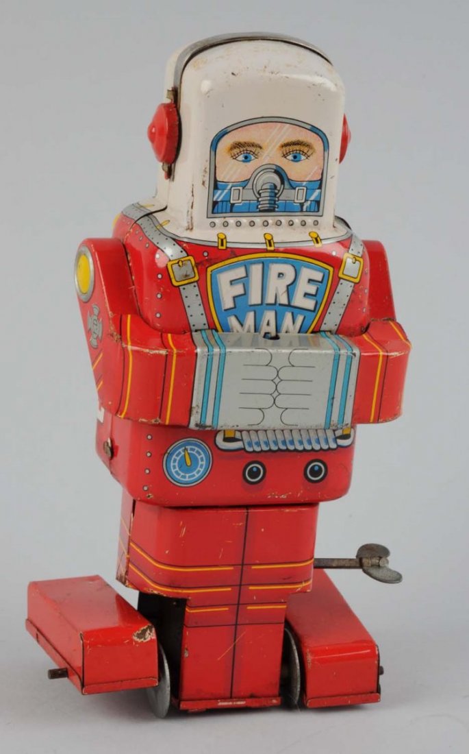 Japanese Tin Litho Wind-Up Fireman Astronaut Toy.: Made by S.Y. Japan. Roller feet on bottom, some scratching where feet meet body. Some factory touch up paint on left side where feet meet body. Missing plastic hose, some scratching and wear throughou