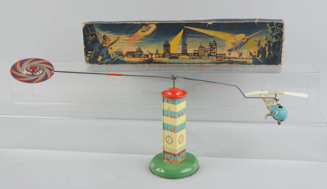 German Tin Litho Wind-Up Statocopter Space Toy.: Includes colorful original box, showing space ship, helicopter and tower. Some tearing and creasing to box lid, also some inside tape repair. Toy depicts a wind-up helicopter with celluloid blades goi