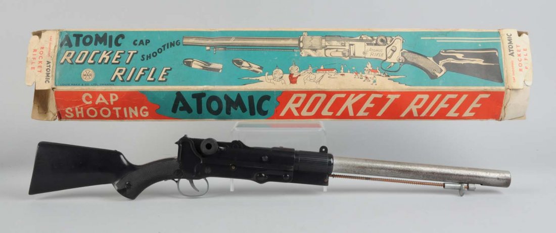 Metal & Plastic Atomic Rocket Rifle In Box.: Made by Marx in the USA. There are no visible scratches or dents to the plastic part of the gun, however the metal barrel has scratches throughout. Gun does not include its projectiles. Includes the o