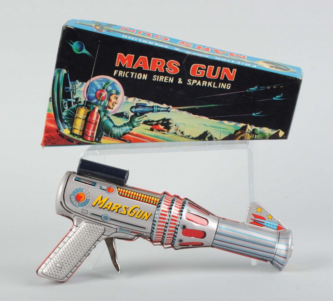 Tin Mars Gun In Box.: Made by Daiya in Japan. Entire gun is made of tin with a small section with plastic windows for sparking action to be seen. There are a couple small, barely visible scratches to the tin litho. It has