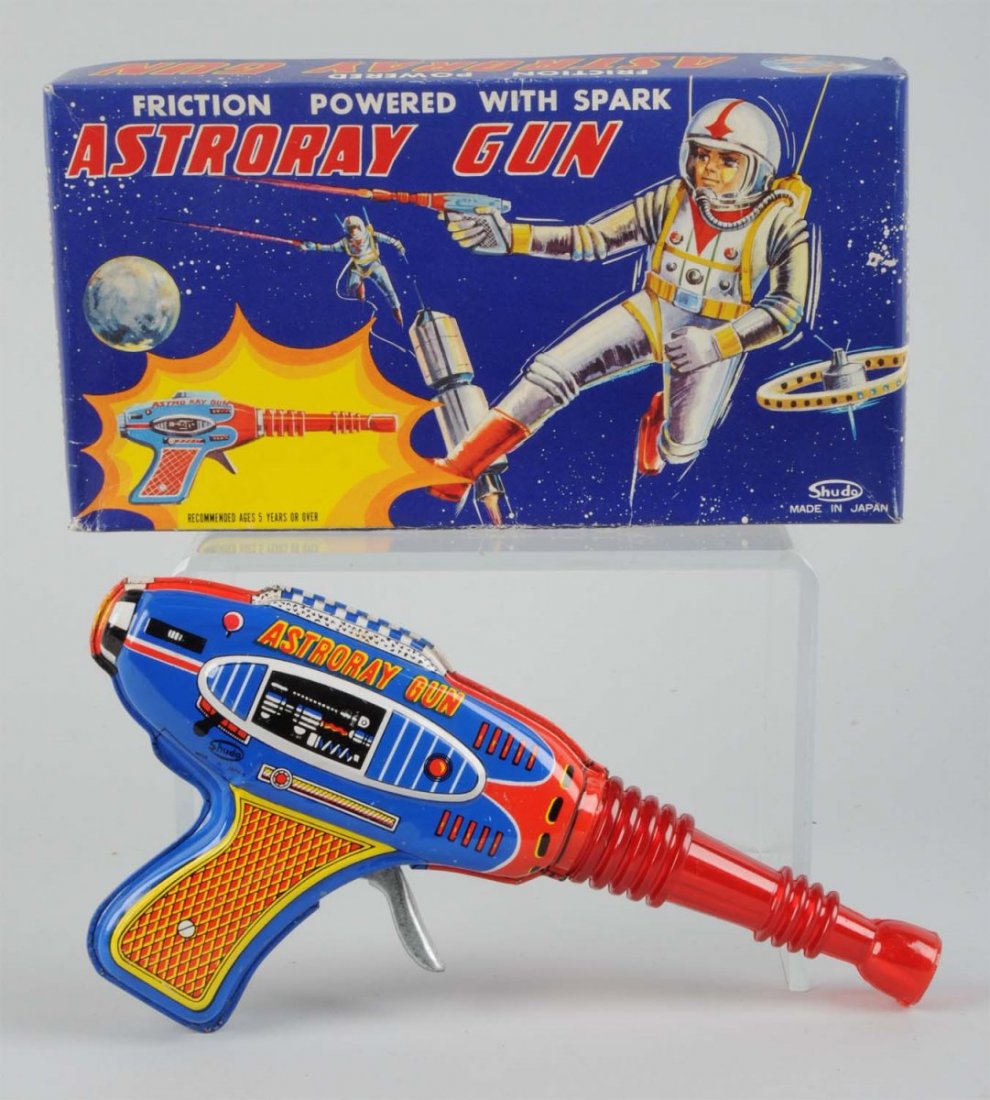 Tin & Plastic Friction Astroray Gun In Box.: Made by Shudo in Japan. Gun is made of tin with a red clear plastic barrel. There are very minor small scratches to the tin litho part of the gun. Both side of the gun read "Astroray Gun". Includes th