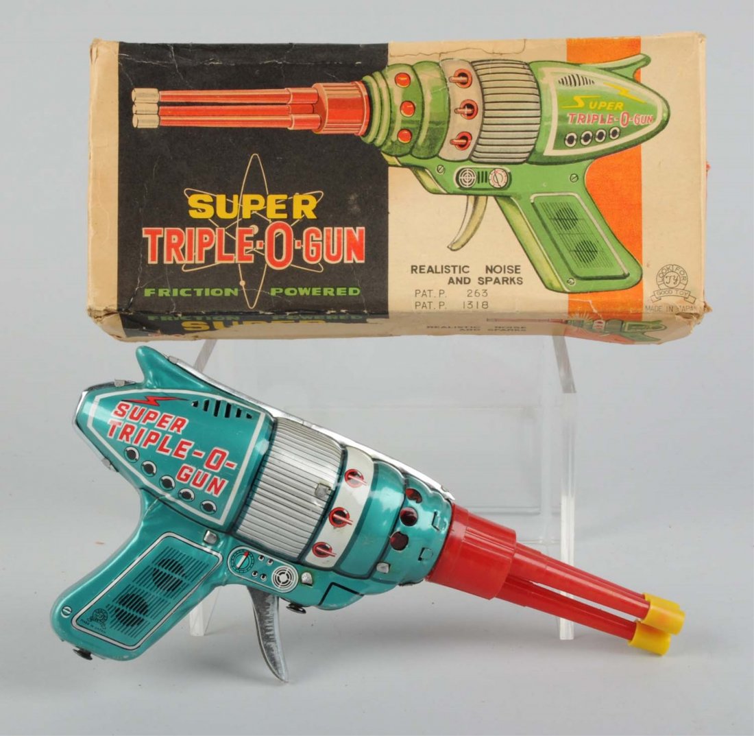 Tin & Plastic Friction Super Triple-O-Gun In Box.: Made by JY in Japan. Gun is made in of tin with plastic barrels. There are no visible major scratches or dents to the tin. Gun is very clean with nice colors and reads "Super Triple-O-Gun" on both sid