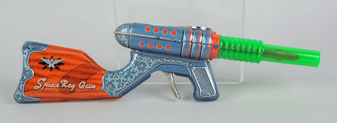 Tin & Plastic Double Barrel Space Gun.: Made by KO Japan. Gun appears to be in a clean condition with no visible scratches or dents to the tin litho. Gun reads "Space Ray Gun". Condition (Excellent - Near Mint). Size 15" L.