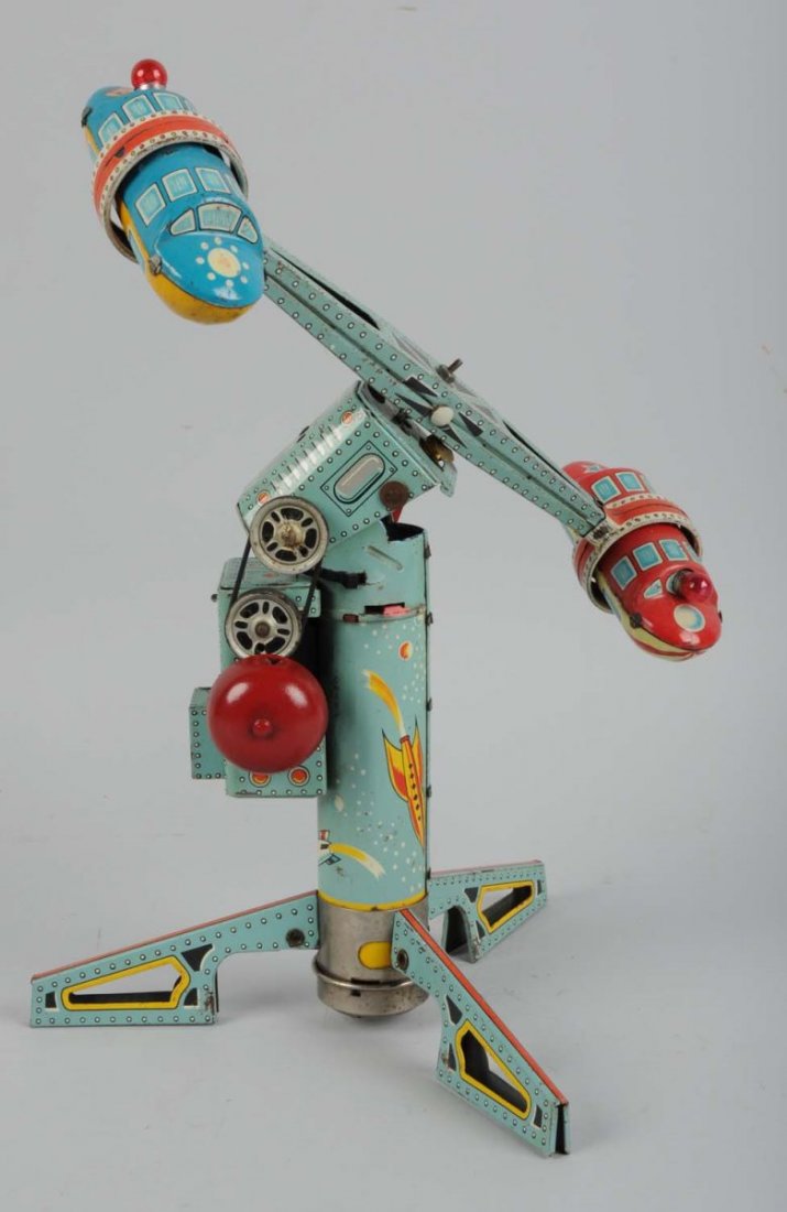 Battery-Operated Tin Litho Rocket Space Ride Toy.: Made by Alps in Japan. The toy has some scratches to the tin litho throughout and a few spots to the base. Otherwise it has very nice and bright colors. Includes the original two rockets attached to t